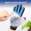 Pet grooming glove with blue bristles removing fur from a hand against a blurred background