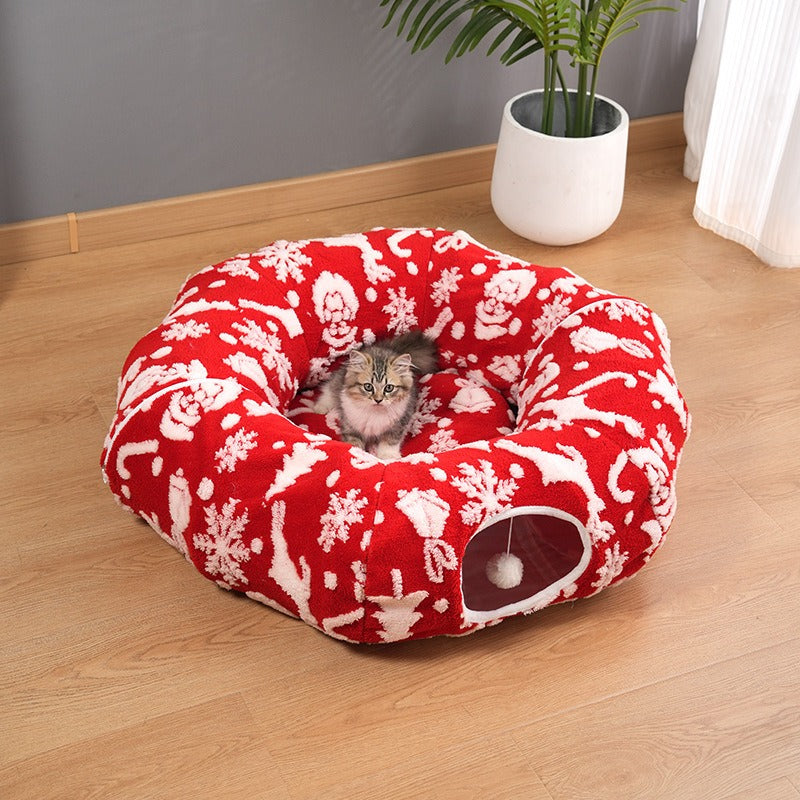 Red Christmas pattern cat tunnel bed with kitten sitting in the center