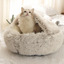 Cat sleeping in plush shell-shaped bed