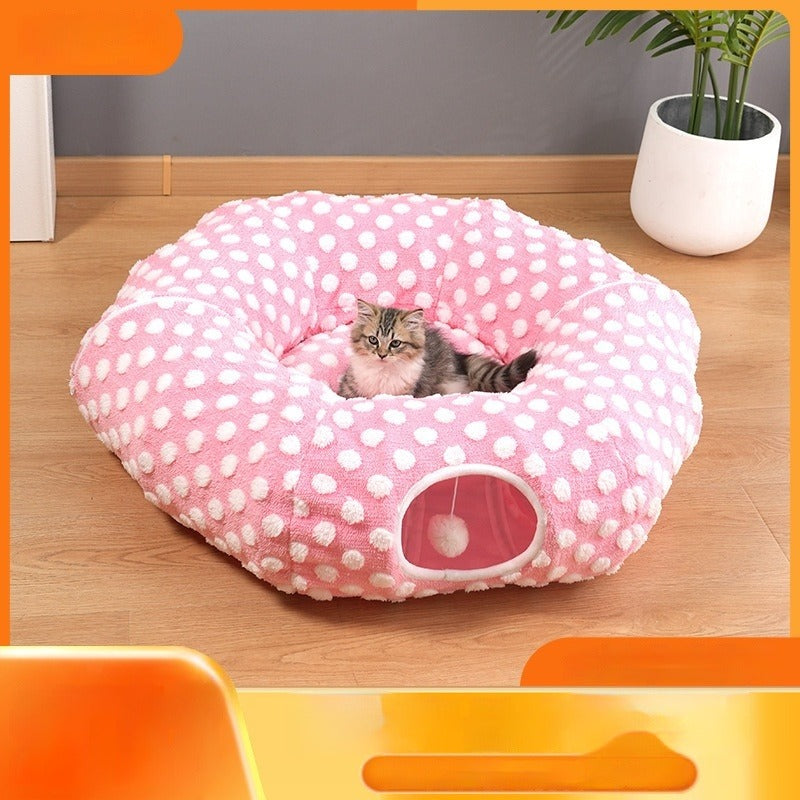 Pink polka dot cat tunnel bed with kitten resting in the center