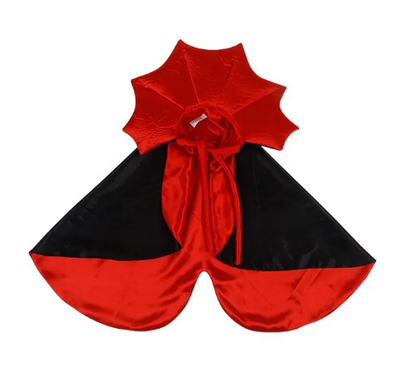 Red and black cape with a large bow on a white background