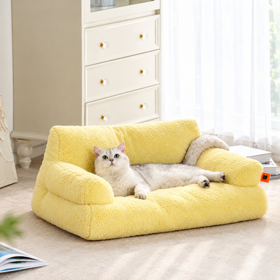 Cozy Plush Pet Sofa Bed in yellow fluffy fabric with a gray cat relaxing on the armrest side