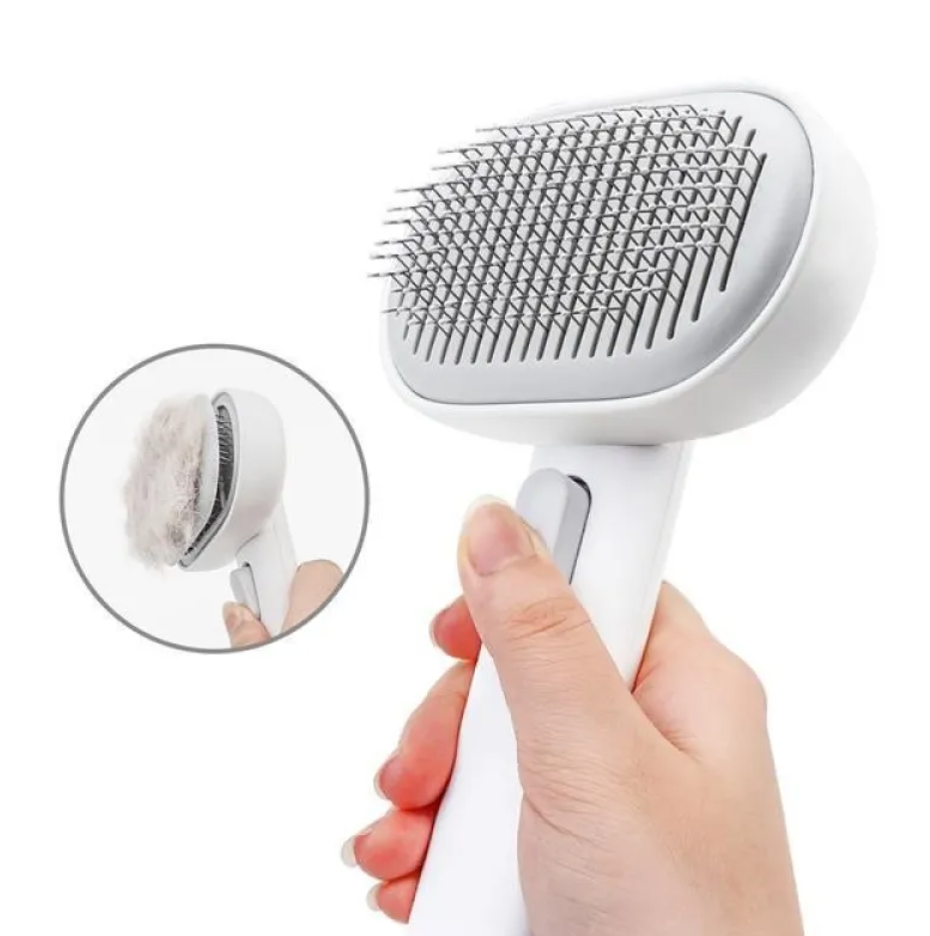 White pet grooming brush with bristles being used on a white background