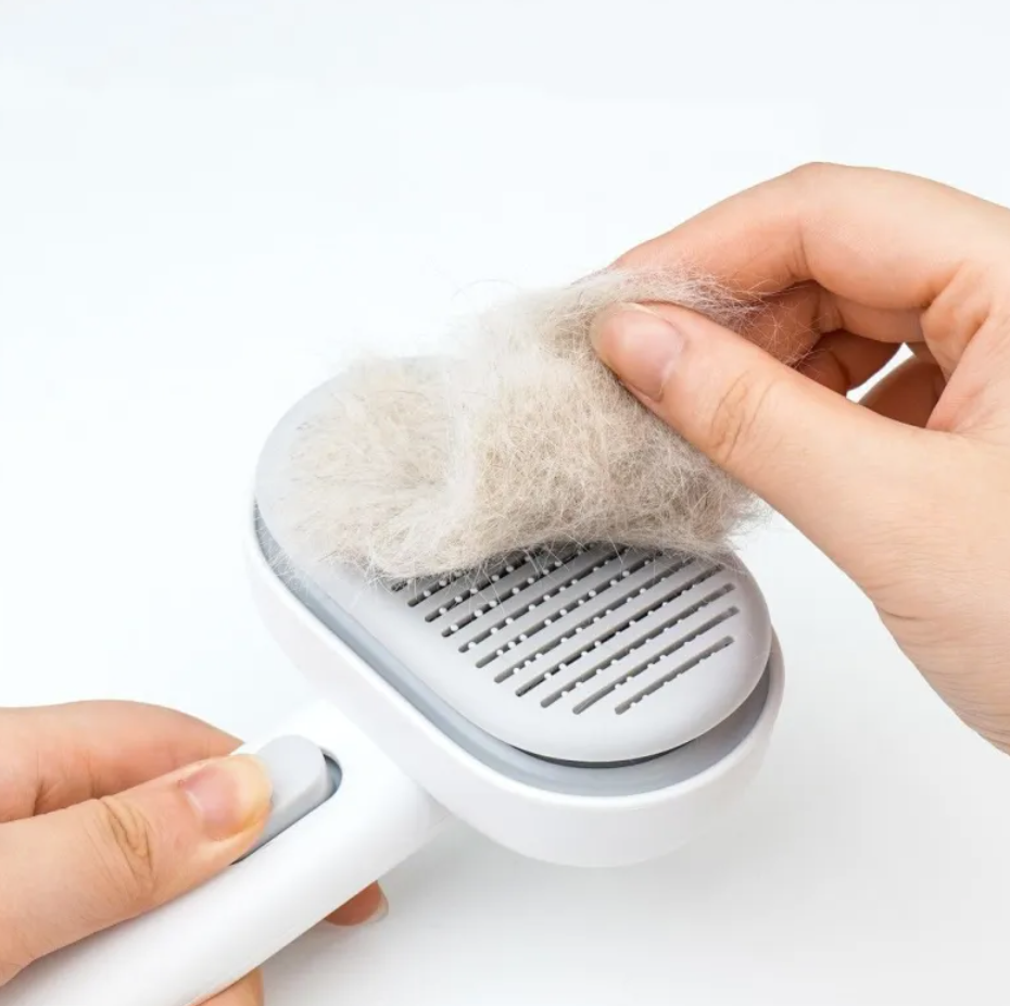 Handheld pet hair remover with collected pet hair on a white background